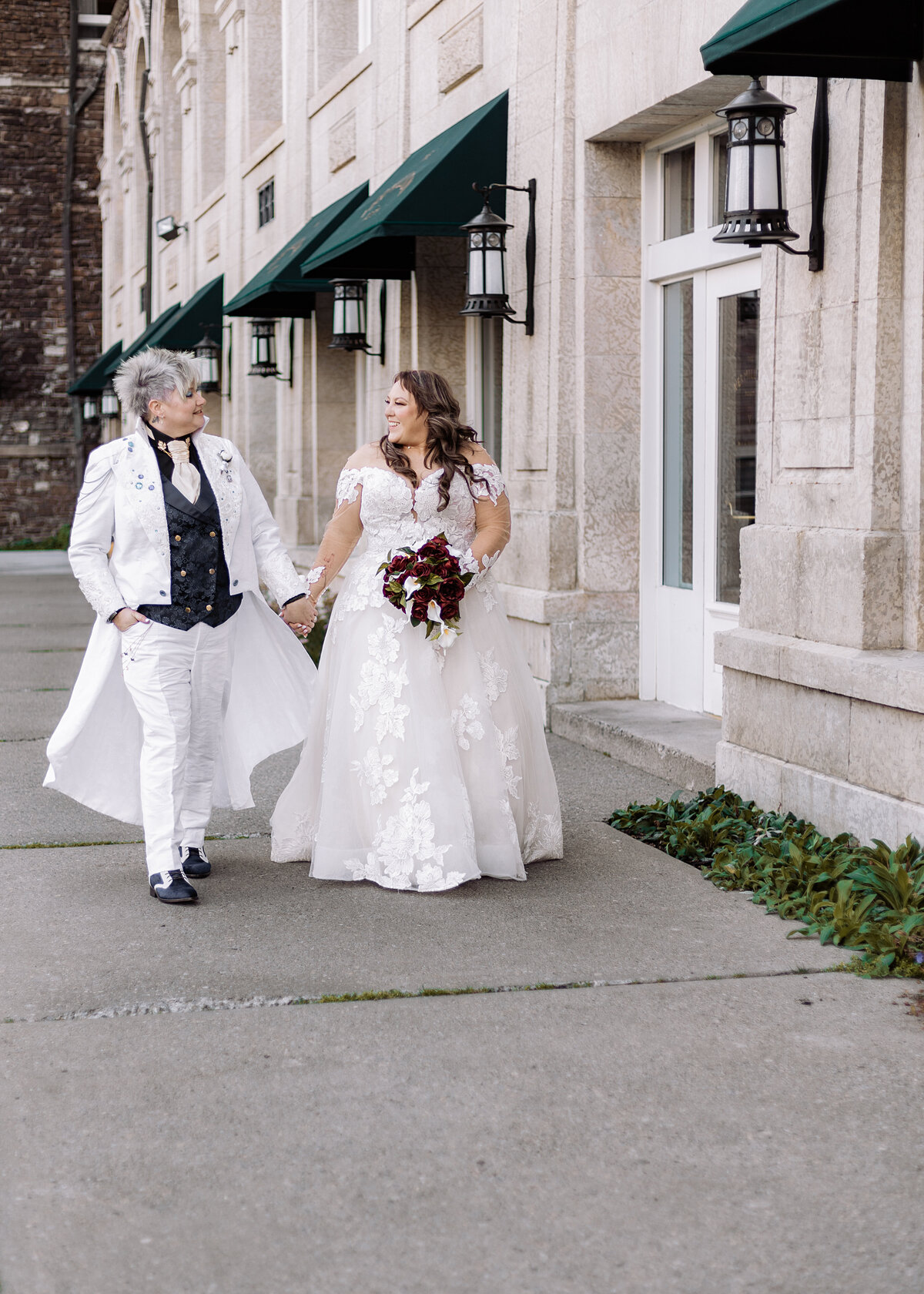LGBTQ Brides walk together beside the Fairmont in Banff