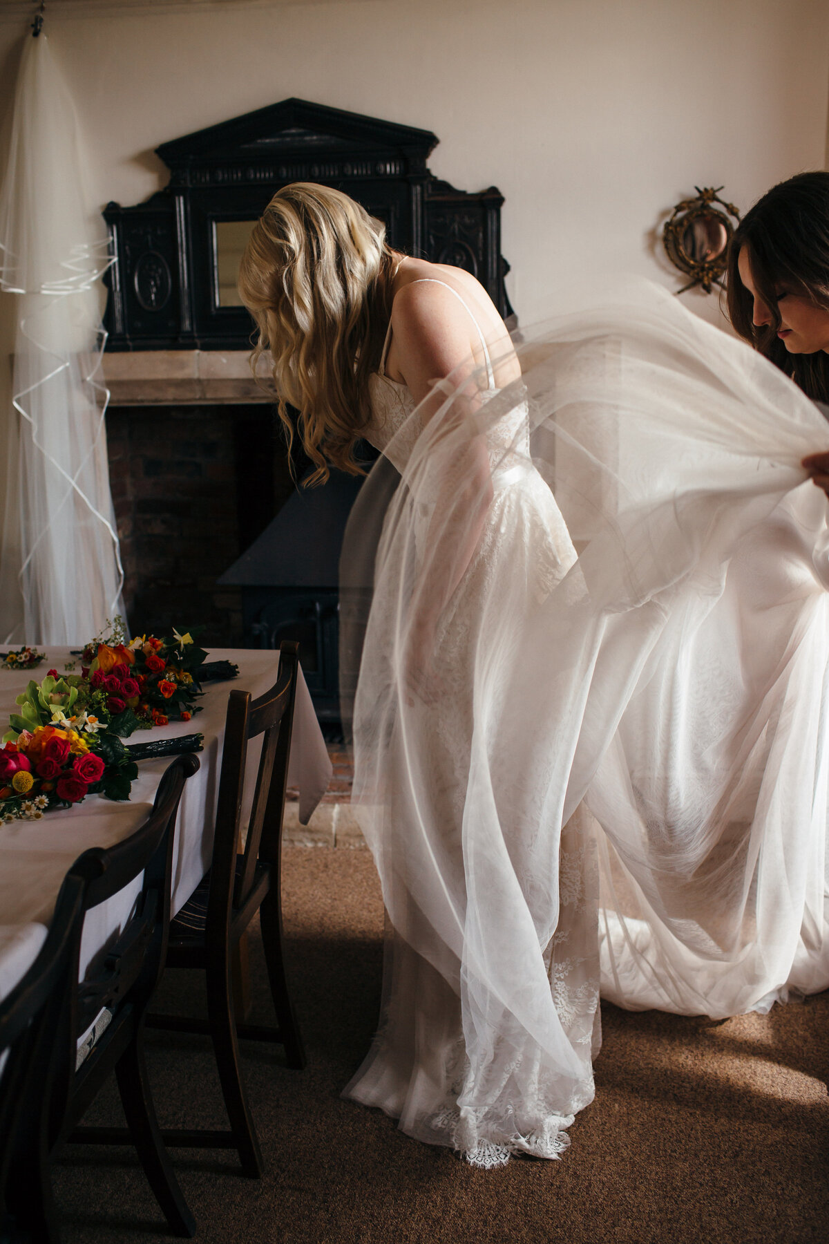 Brides dress is adjusted 