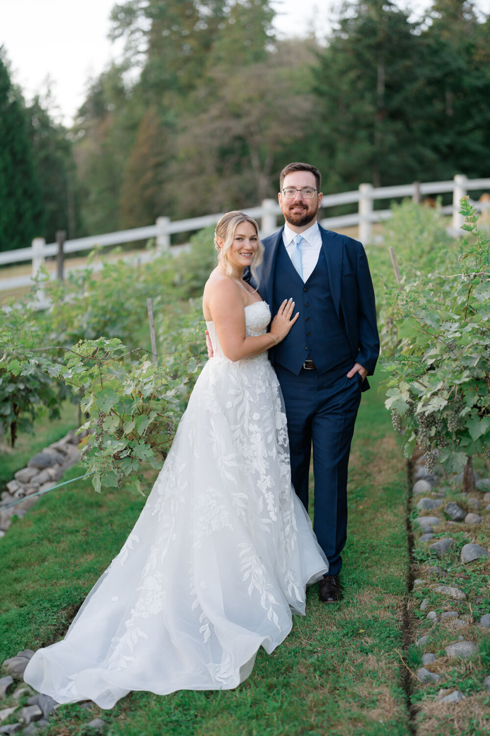 Couple posing in a vineyard at sunset
