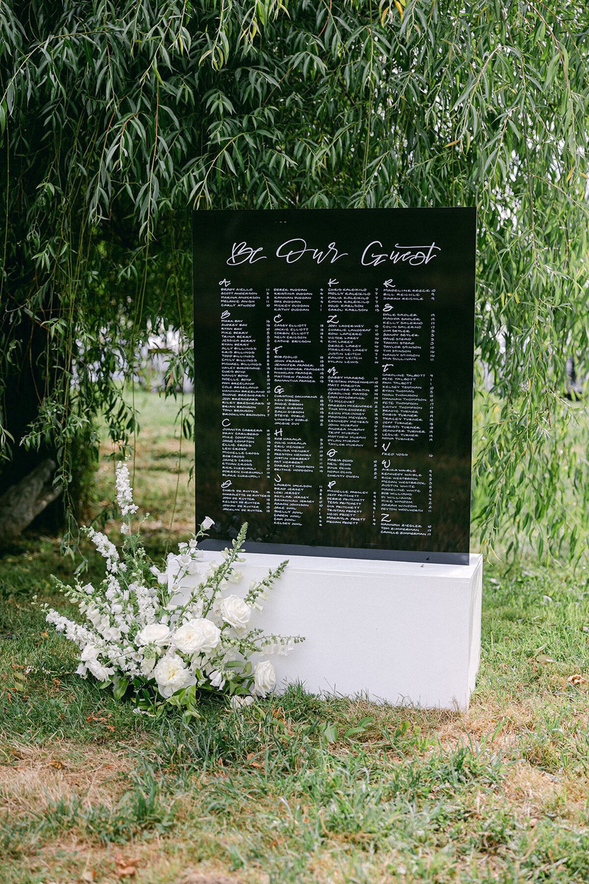 Custom black and white seating chart with calligraphy sitting in a white box at an oregon garden wedding venue representing full service design and calligraphy by Life in Letters.
