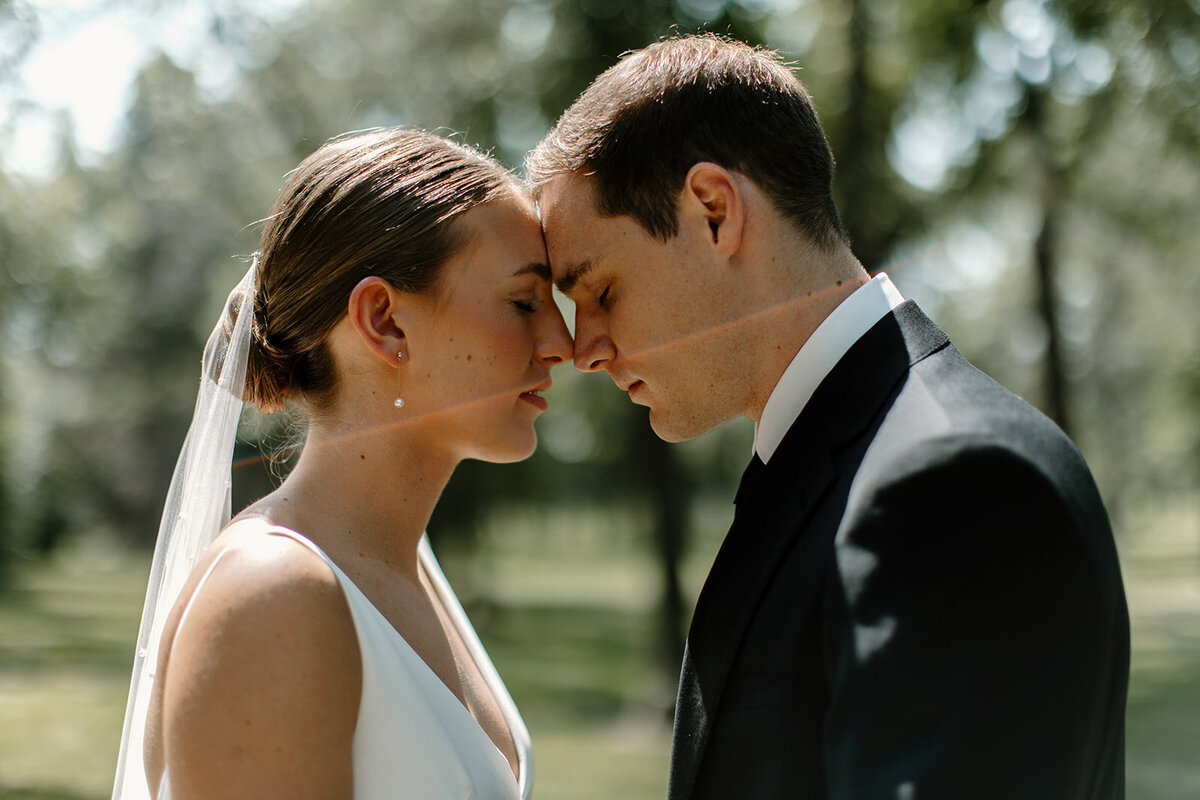bride and groom resting their foreheads together