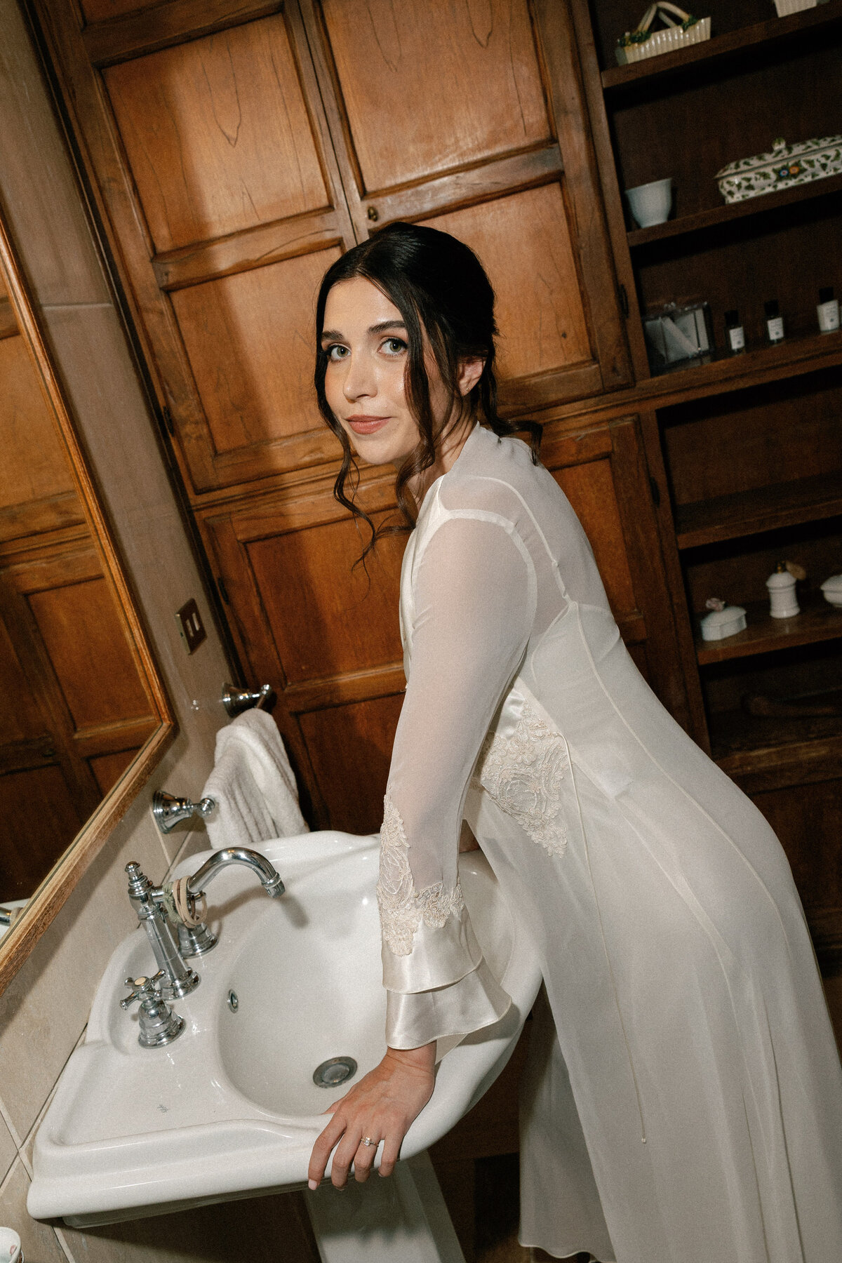 Romantic getting ready bridal portraits in the suite of Villa La Selva