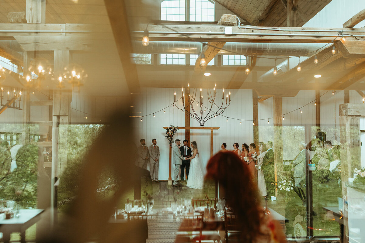 Wedding ceremony in a modern white winery style barn at Willowbrook