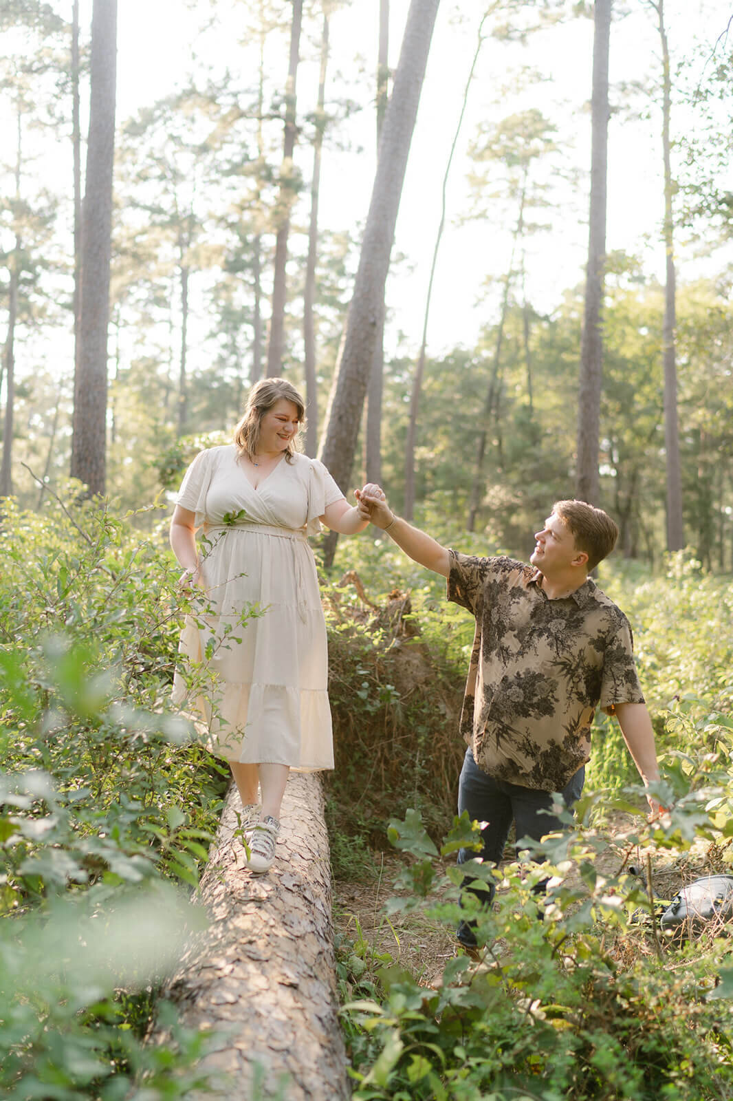 couple enjoying their engagement session in the forest