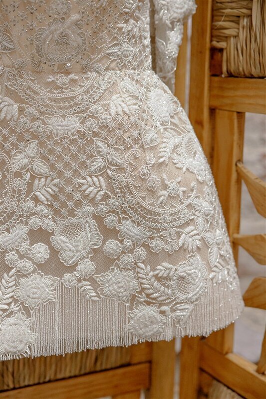 Details of Sydney Watters wedding dress with lace and fringe