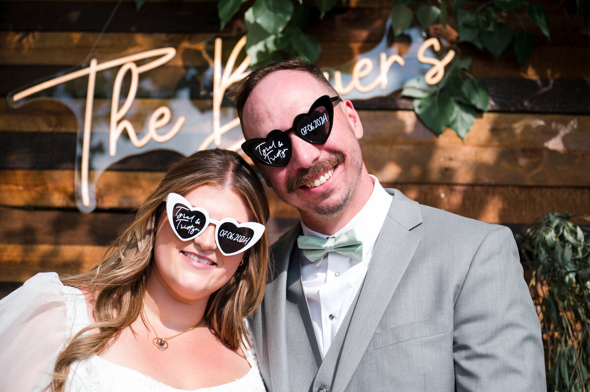 bride and groom wearing heart sunglasses celebrating their wedding