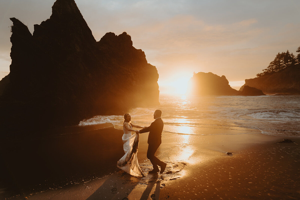 couple dancing on beach at sunset