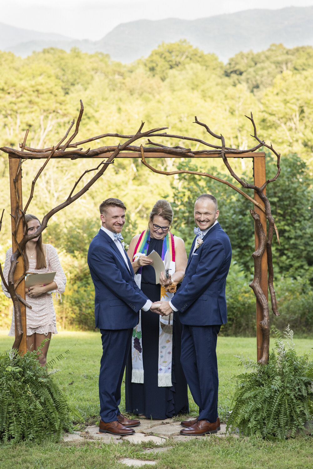 LGBTQ couple smiling during wedding ceremony at Twisty Maple wedding