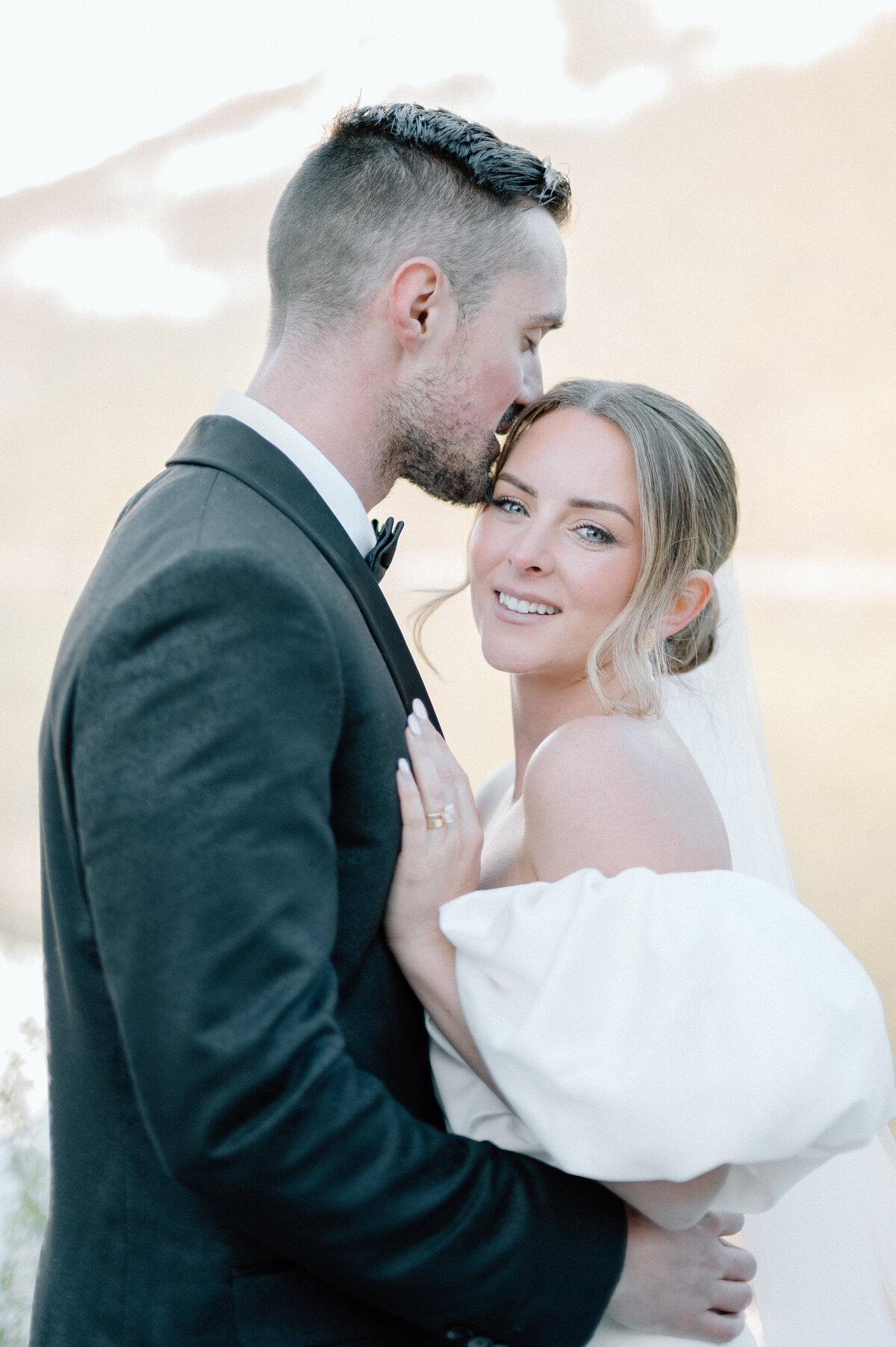 Bride and groom embrace at Lake Louise with golden hour glow