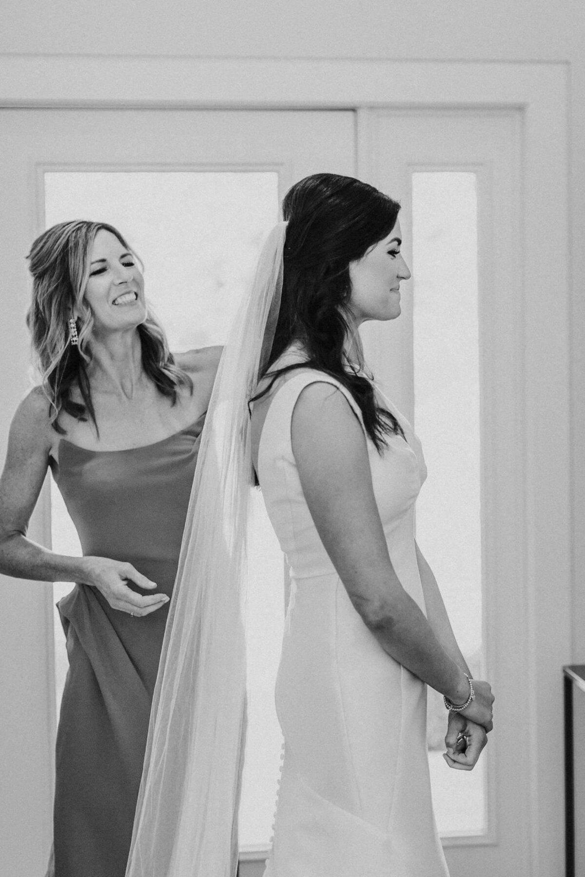 Mother of the Bride Places the Bride's Veil at a Luxury Michigan Lakefront Golf Club Wedding.