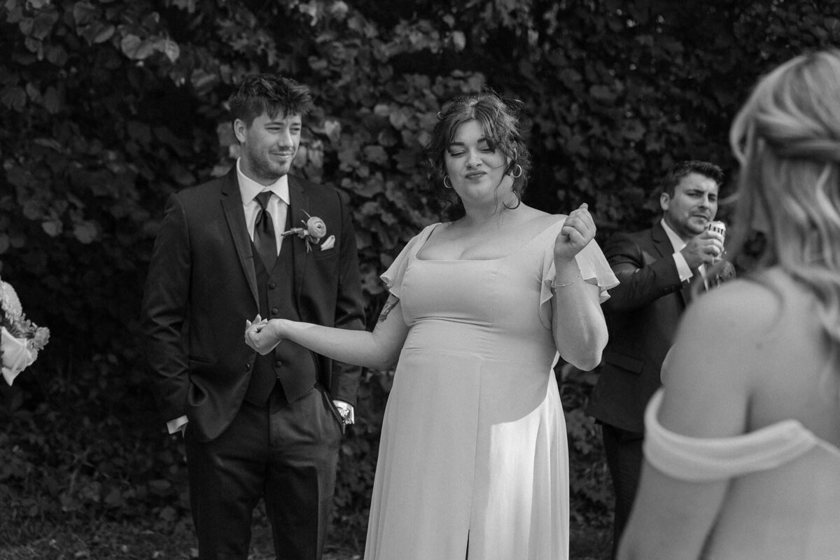 Wedding guests dancing in a garden and smiling 