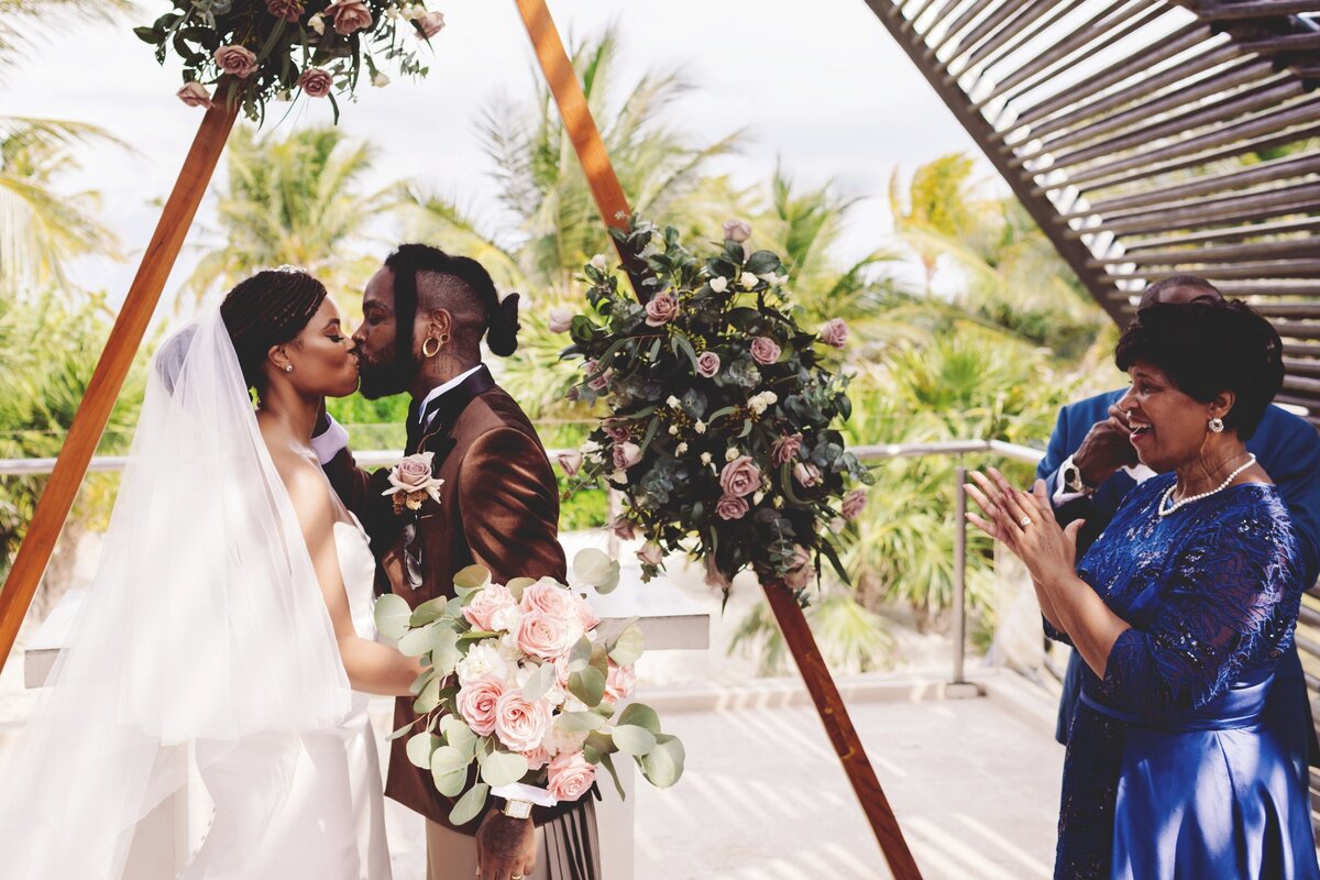 Bride and grooms first kiss at Cancun wedding