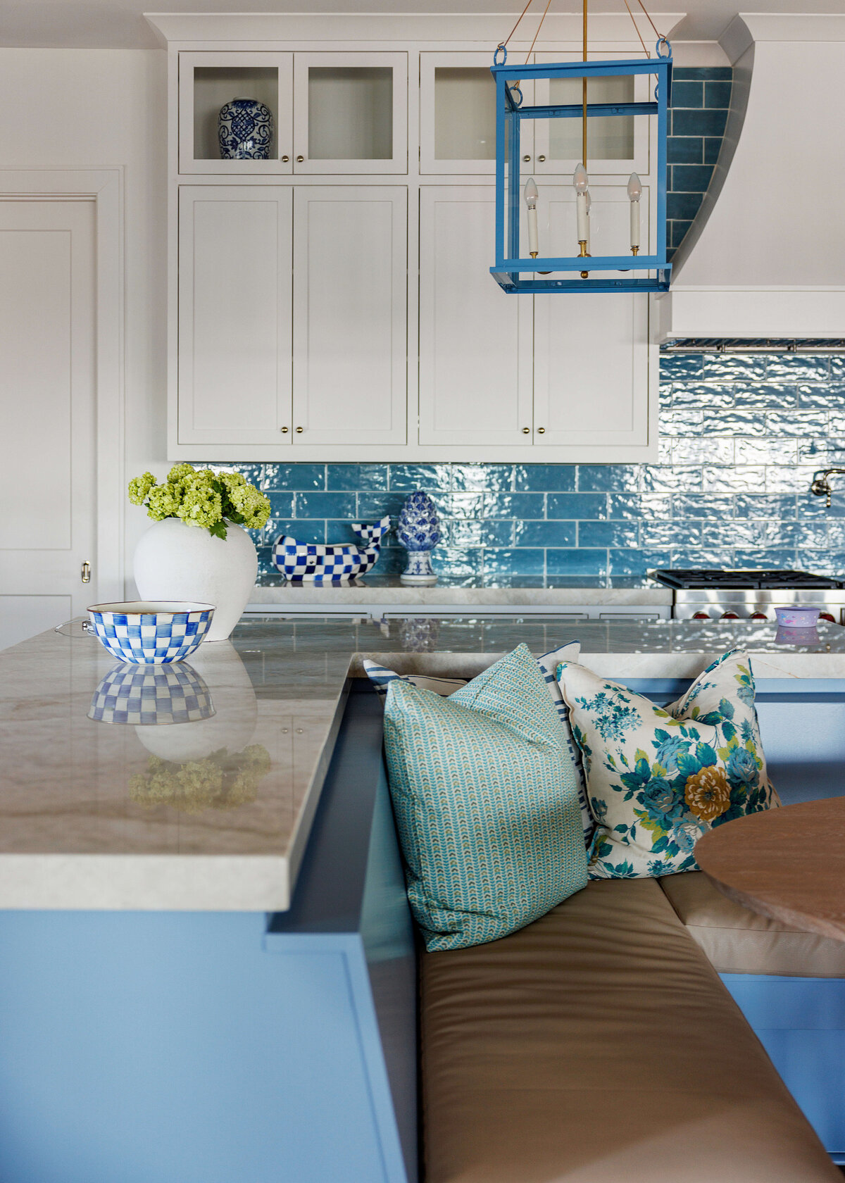 oyster creek studios lighthouse on the lake turquoise tiled kitchen with white cabinets and brown cushioned bench