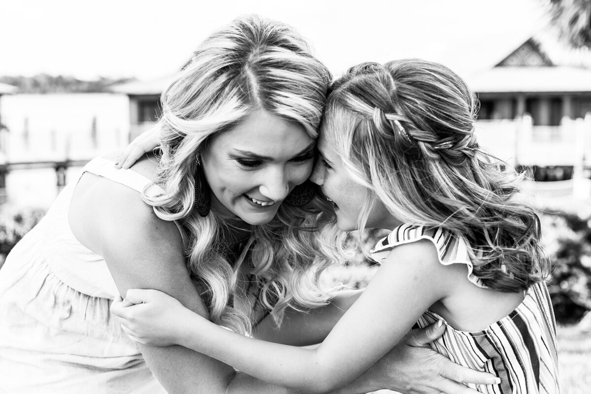 Black and white photo of mom and daughter playing and laughing