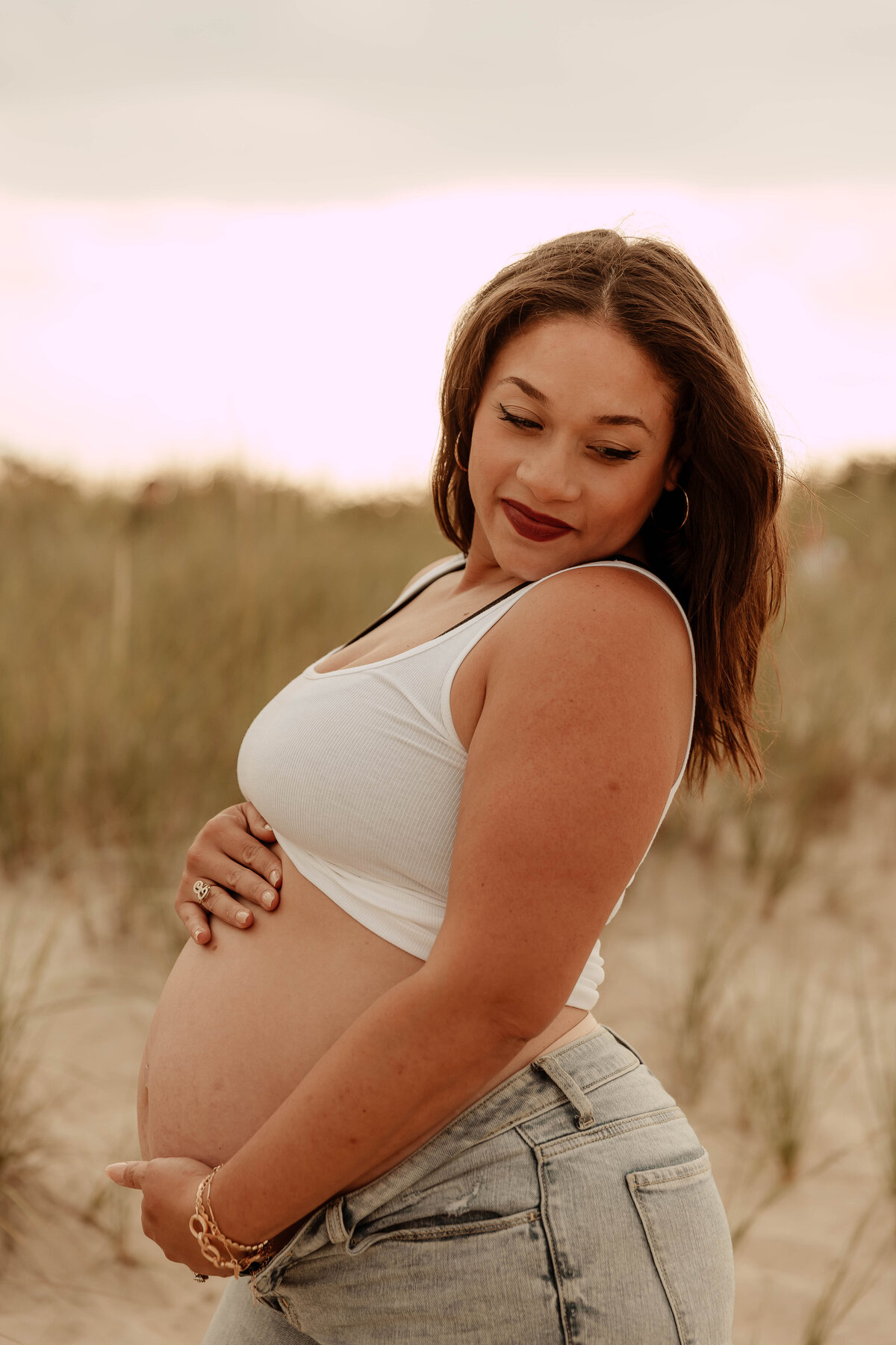 A pregnant mother posing at Sandy Hook beach in NJ