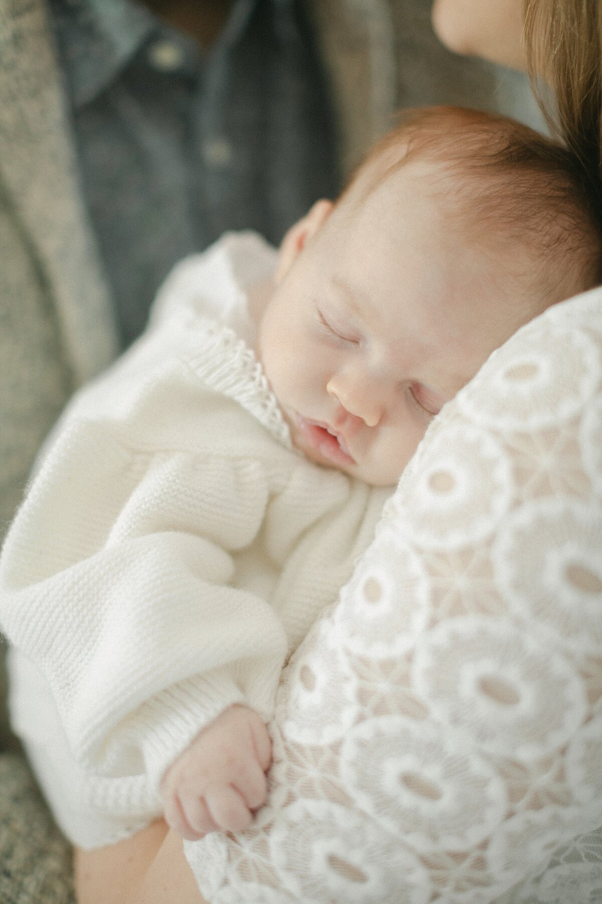 Mother holds child during newborn session in Boston.