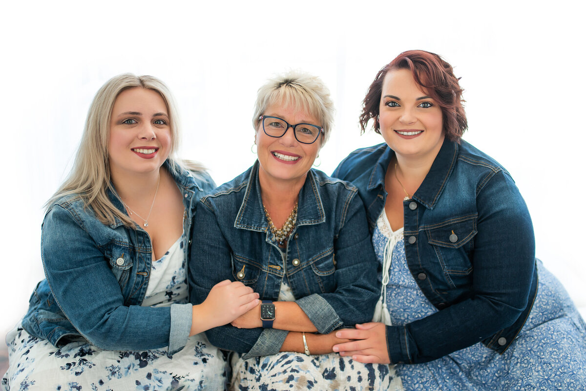 A team of three Pewaukee business owners sit for their professional branding session in our Waukesha photo studio.