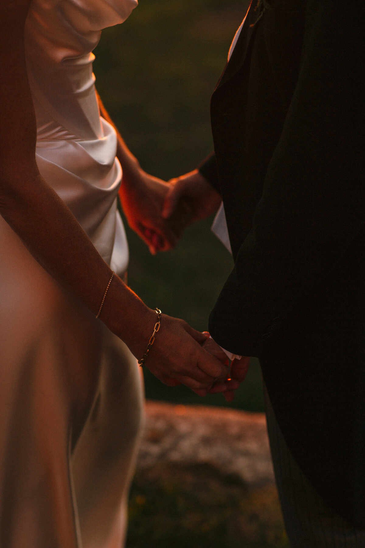 sunset portraits of the wedding couple just the hands holding 