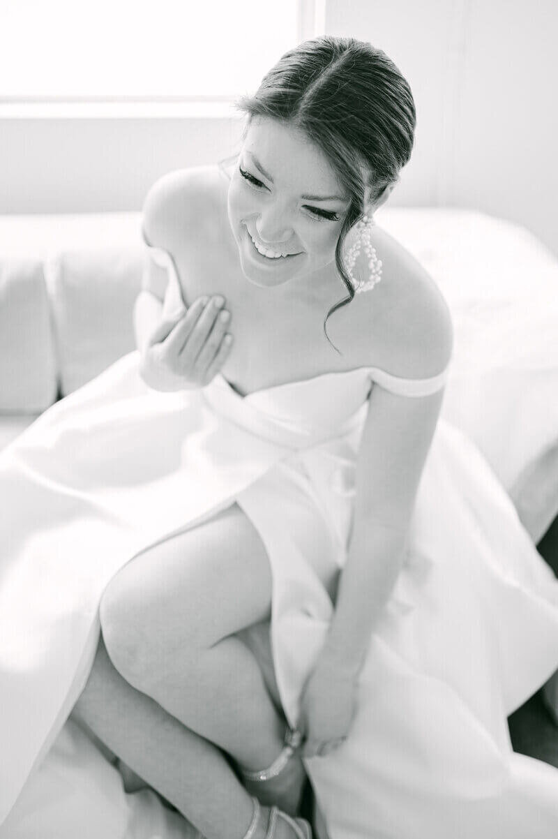 Bride putting on her wedding shoes planned by wedding planners chicago il