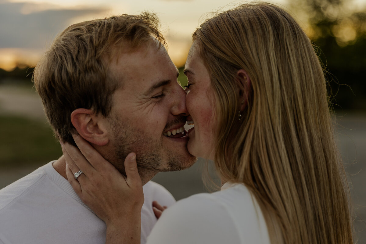 Close up photos of a couple holding each other while they laugh and kiss in Wyoming