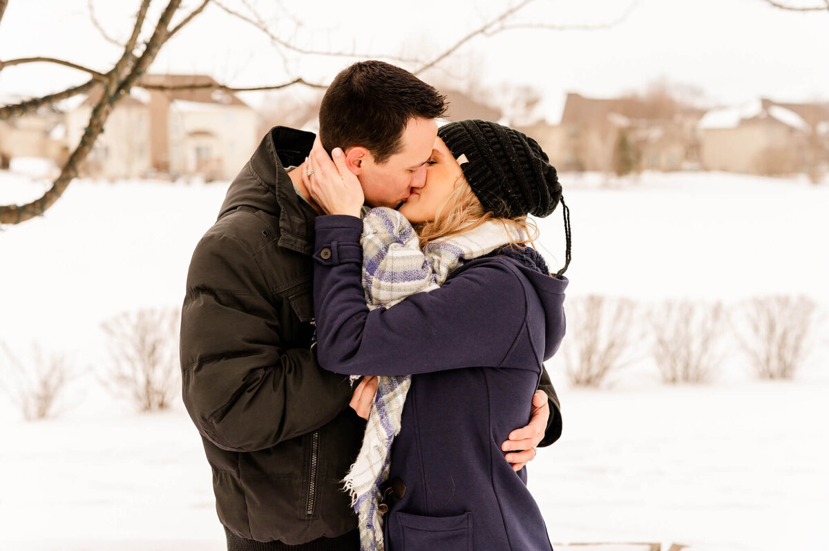 Couple kissing in the winter during a couples session near Naperville, IL.