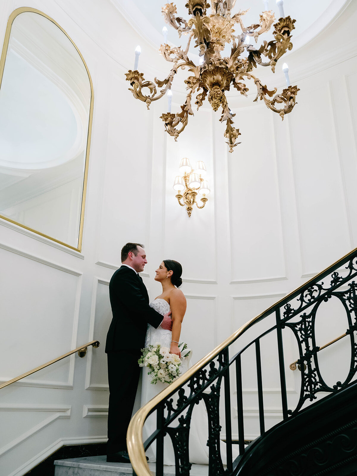 Bride and groom pose on the staircase for an intimate moment