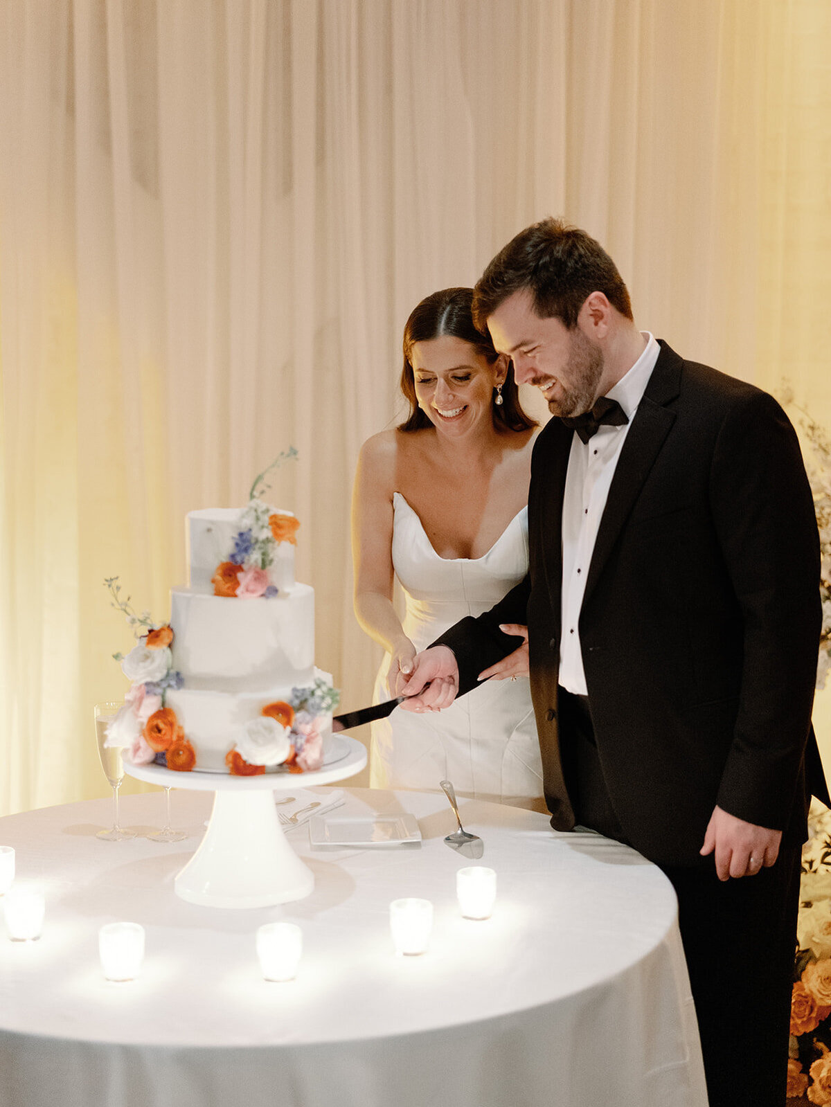 bride and groom cutting wedding cake