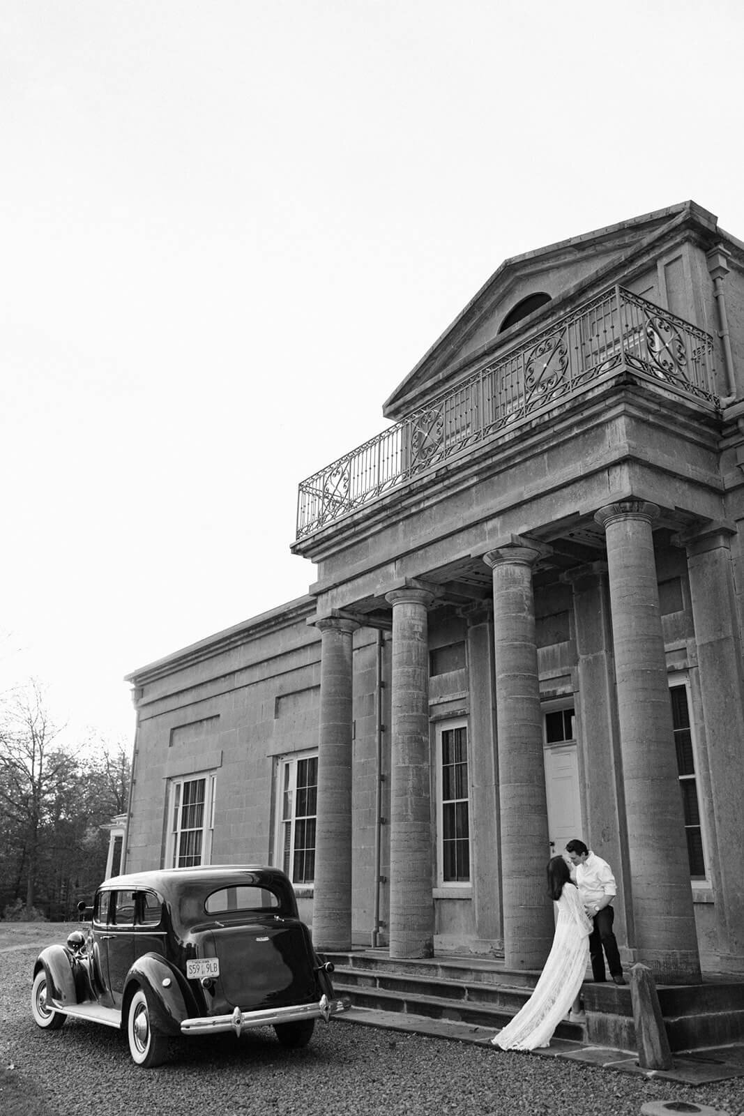 Couple outside historical building at maternity shoot in Finger Lakes, NY