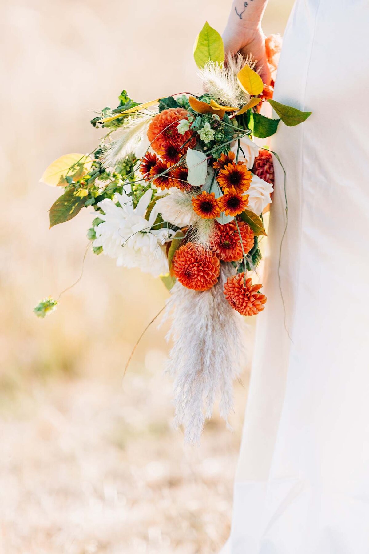 Close up of orange bridal bouquet at Blue Mountain in Missoula, MT