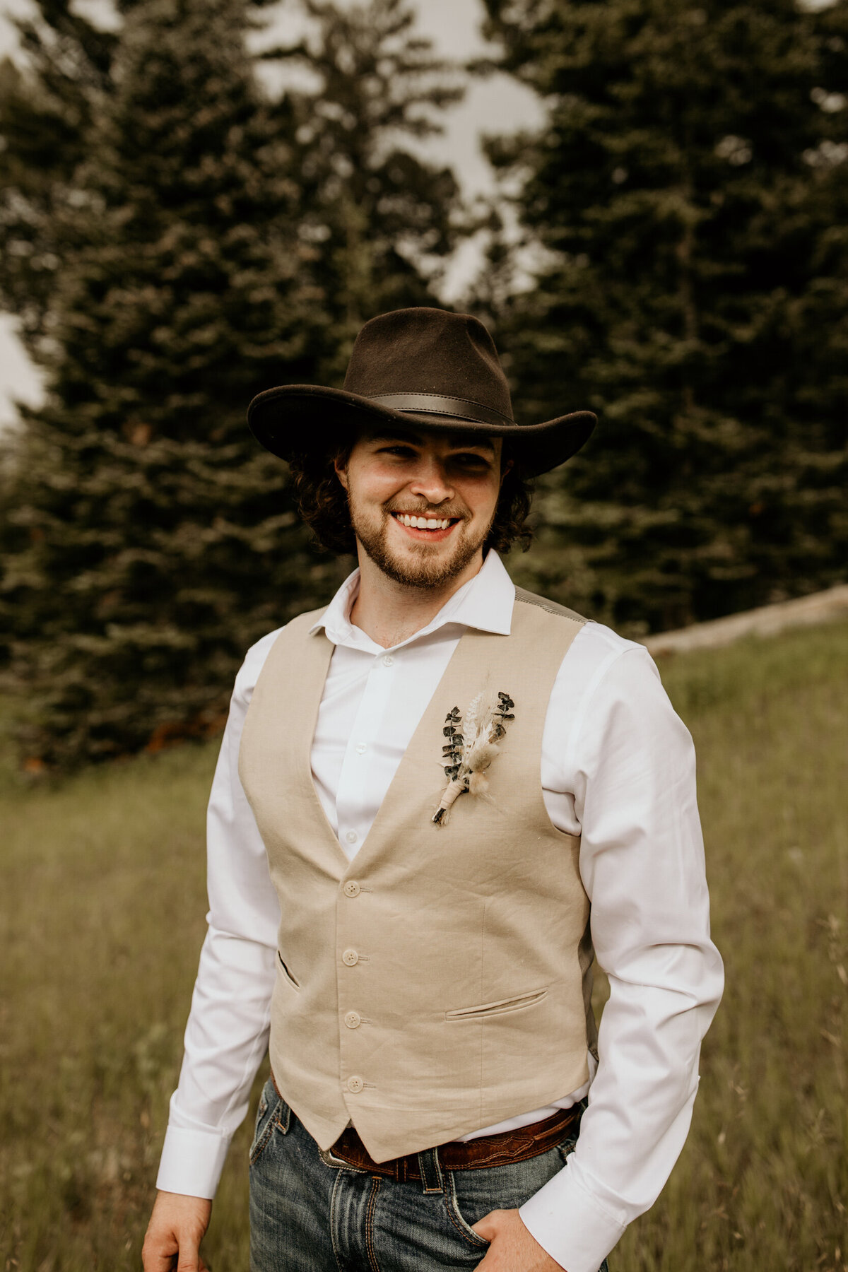 groom wearing a cowboy hat and tan vest in ALbuquerque