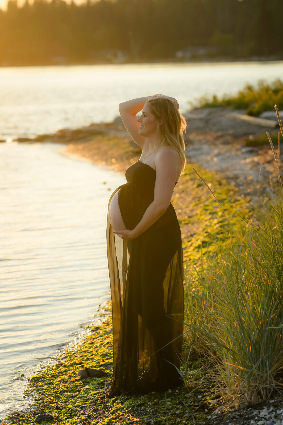 The glow of the setting sun accentuated the growing baby bump of this mom to be. Photographed by E. Benecki Photography.