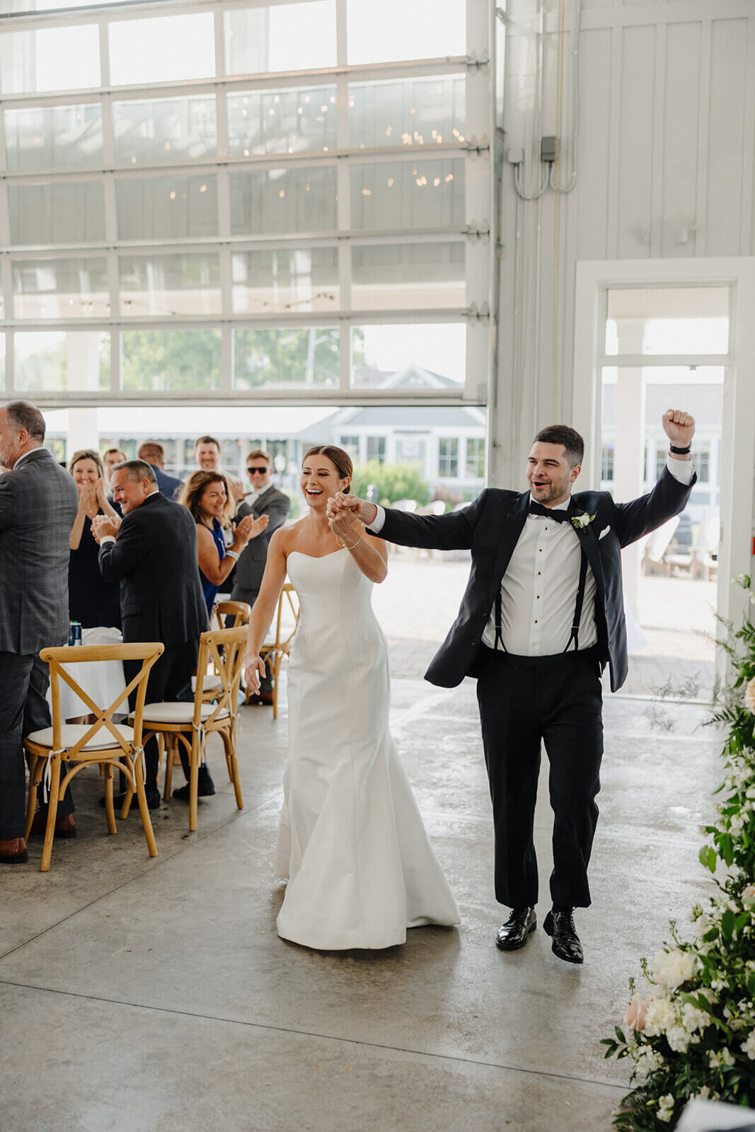 bride and groom entering wedding reception at Canandaigua Country Club, NY
