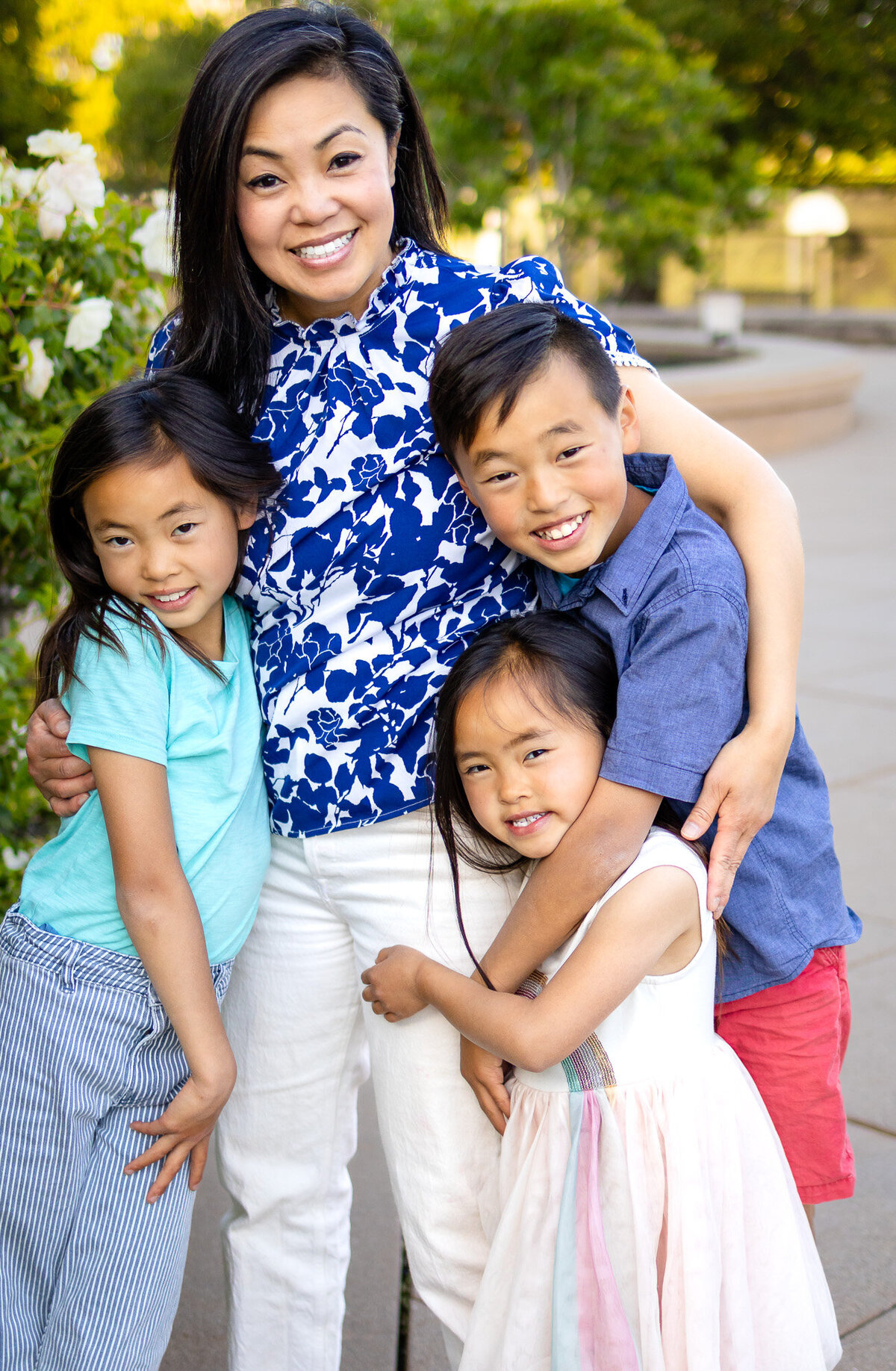 Mother hugging three children closely during Bay Area Family Portfolio photos at Kohl Mansion Burlingame – Ellobelle Photography