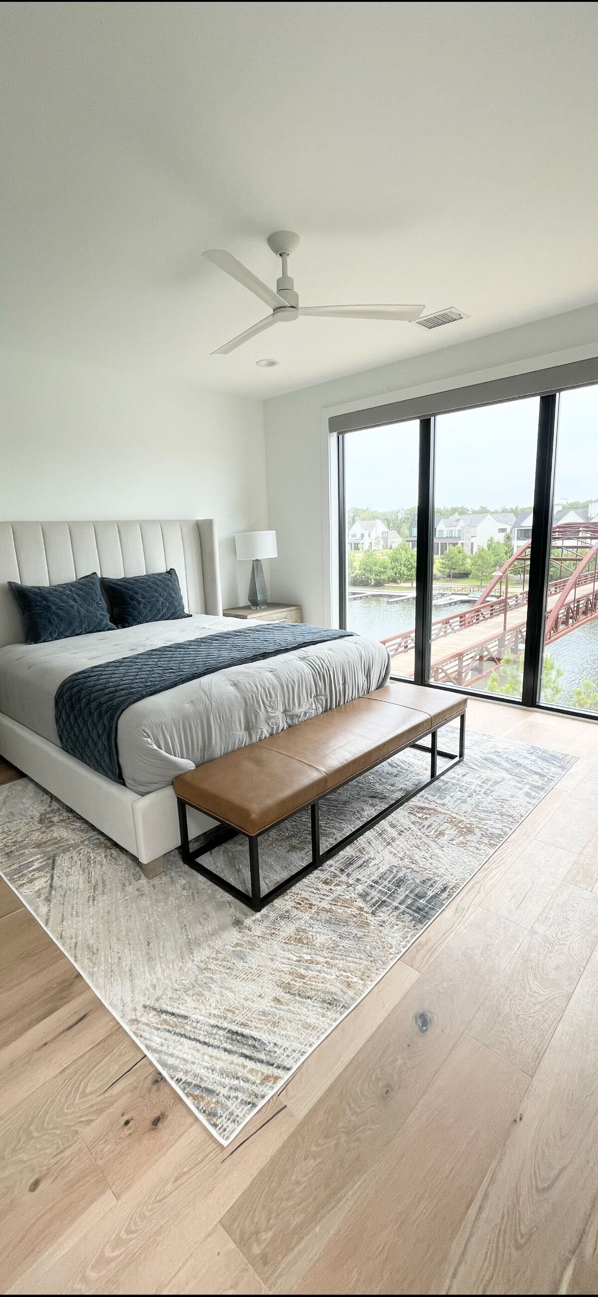 Creative interior design contractor project featuring a bedroom with elegant dark blue decorations. The sophisticated setup includes complementing furniture and accents, creating a cozy and stylish atmosphere.