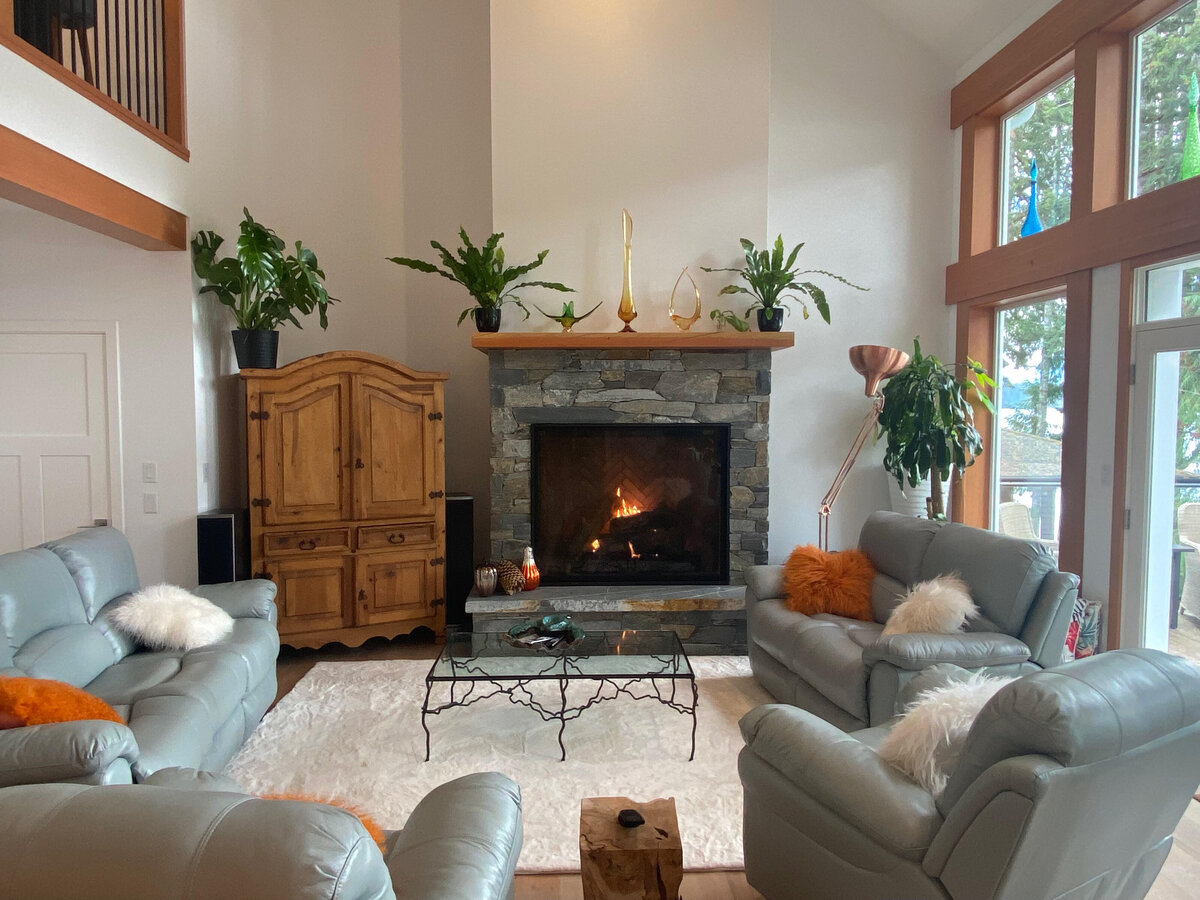 West coast living room interior design with stone fireplace.