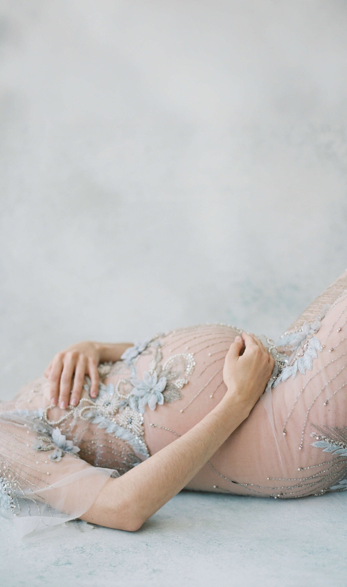 san francisco maternity photography with pregnant woman laying on bed wearing lace