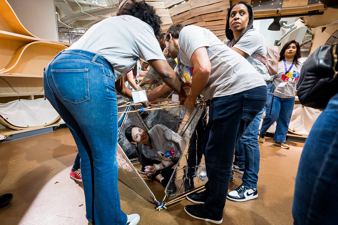 Corporate event photography of participants engaged in interactive activity during professional retreat new jersey.
