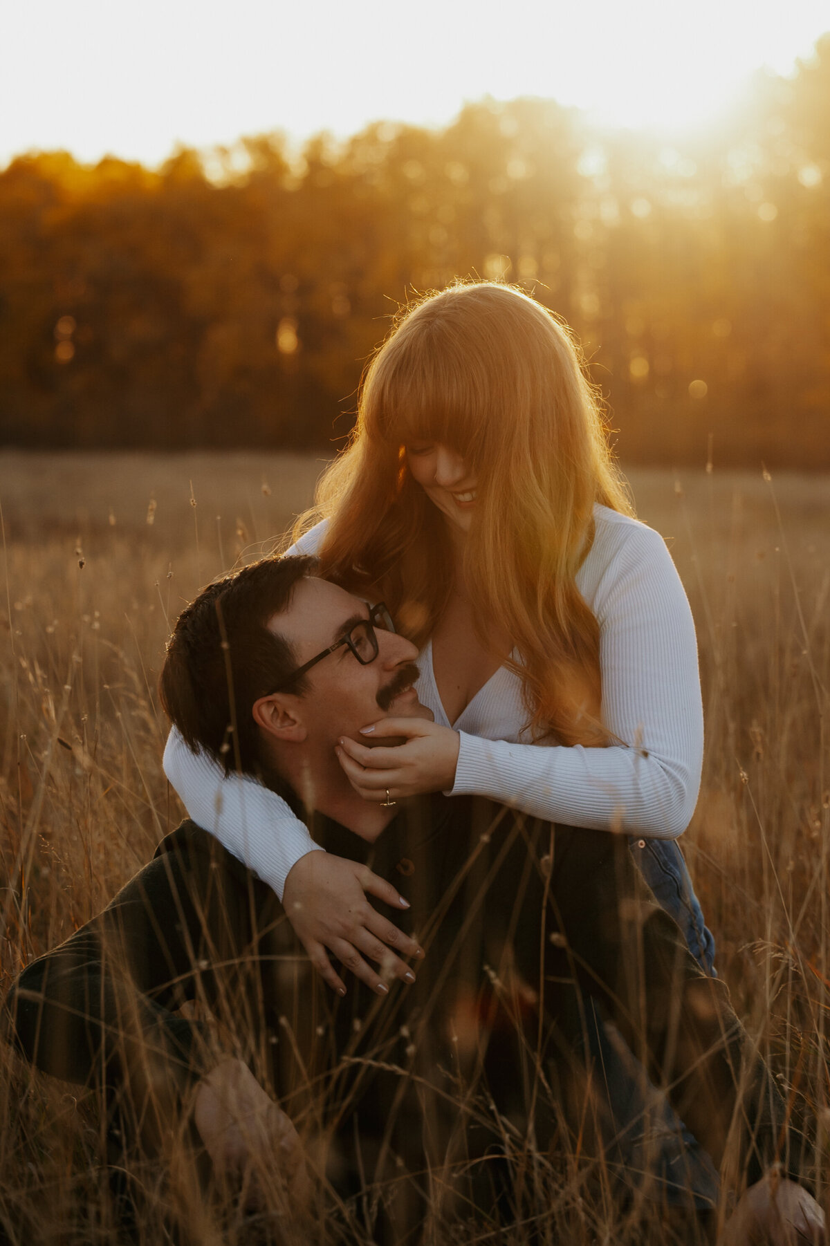 Cozy couples photo in farmers field during fall in Edmonton Alberta