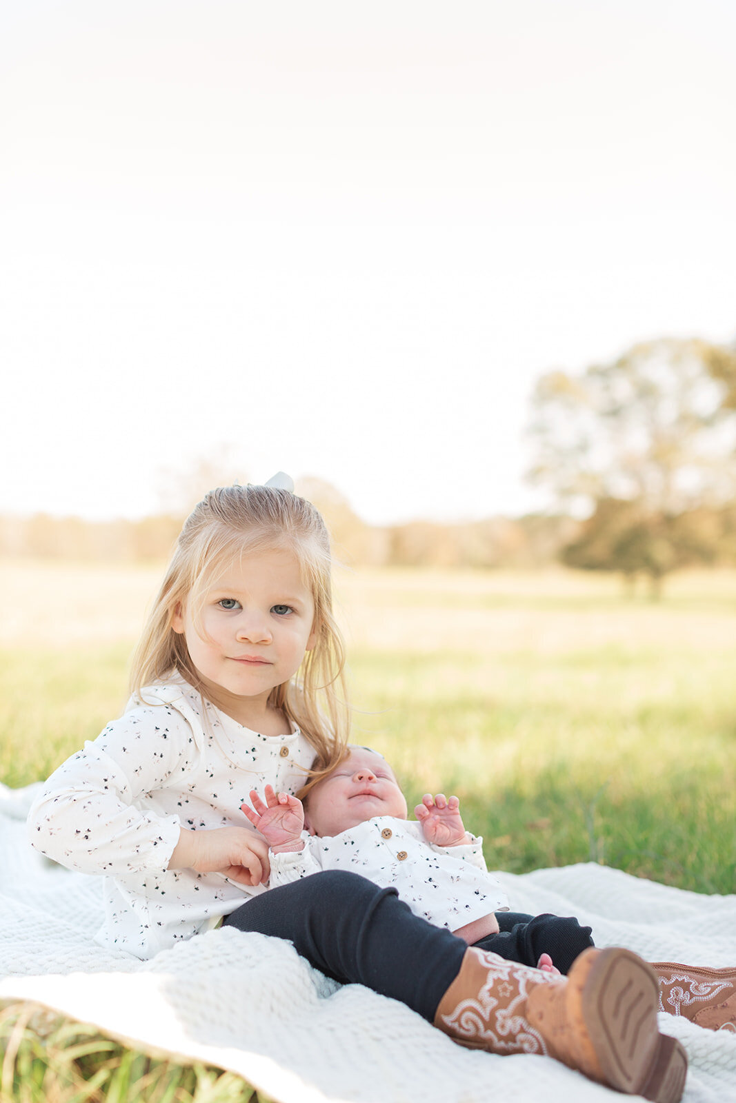 Siblings cuddling during family portrait session
