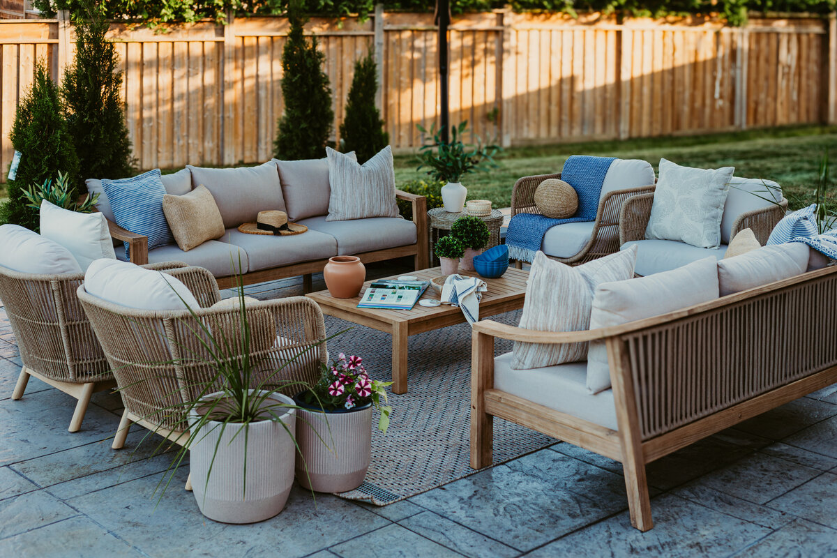backyard patio with two sofas and accent chairs with coffee table in the center