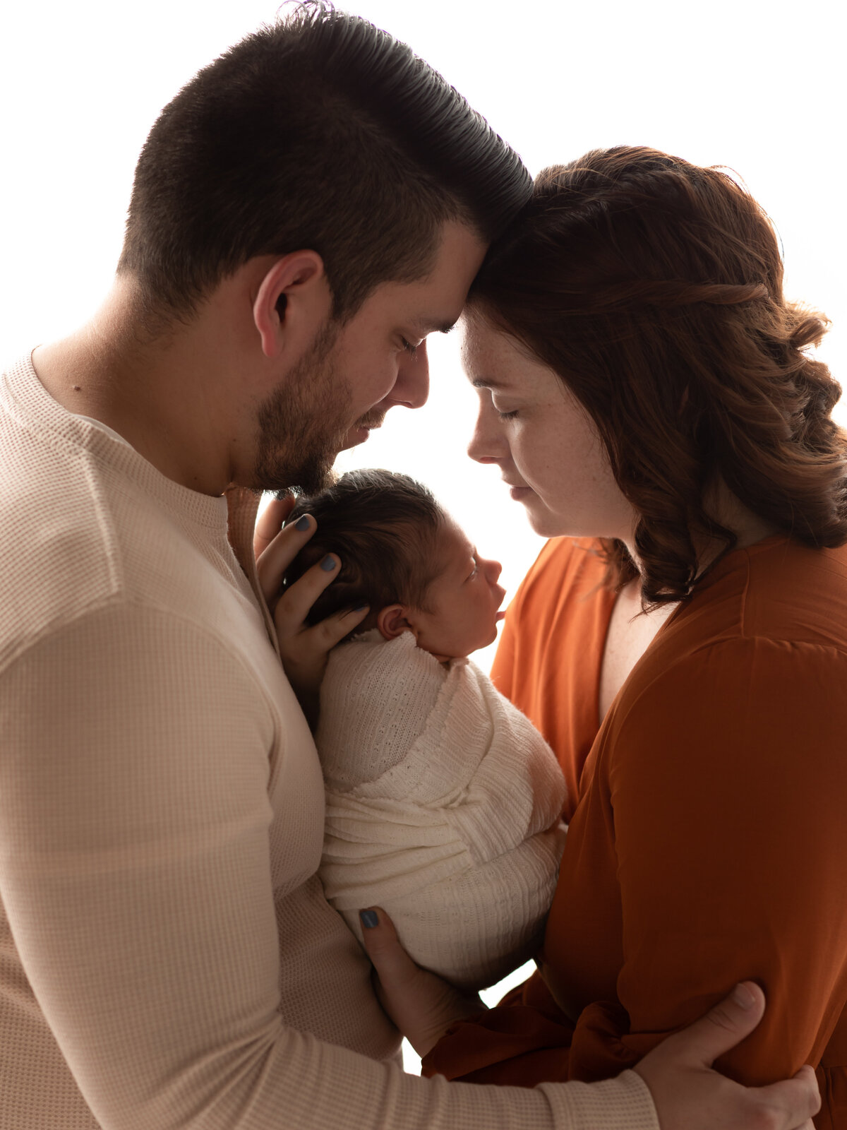 mom and dad holding newborn son for studio portrait cleveland newborn photographer
