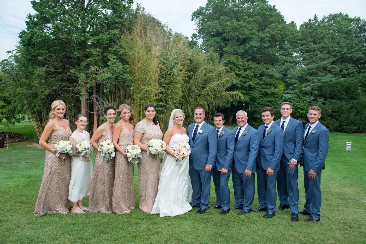 Bride and groom posing with bridal party at Huntington Crescent Club
