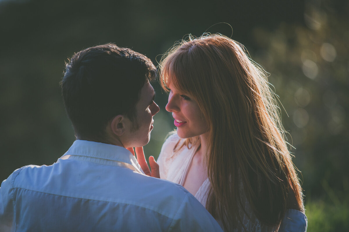 Partners smile and stare at each other in Big Sur.