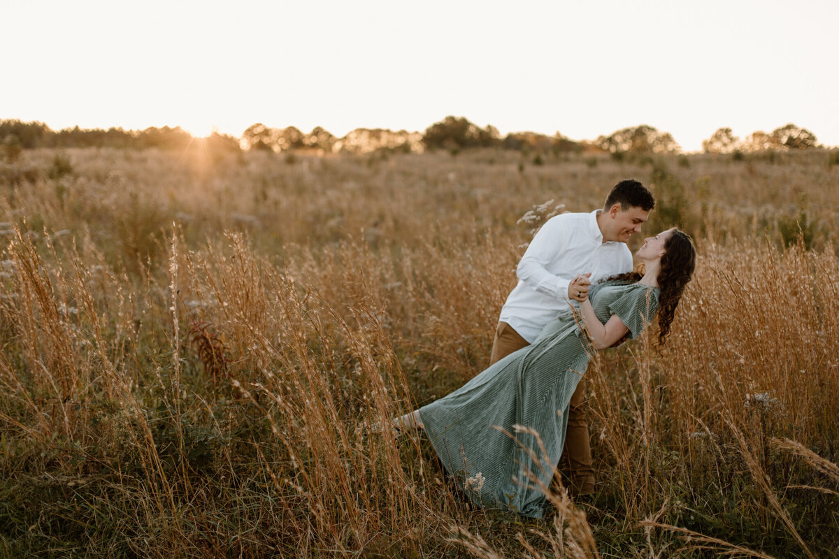 engaged couples standing in a field