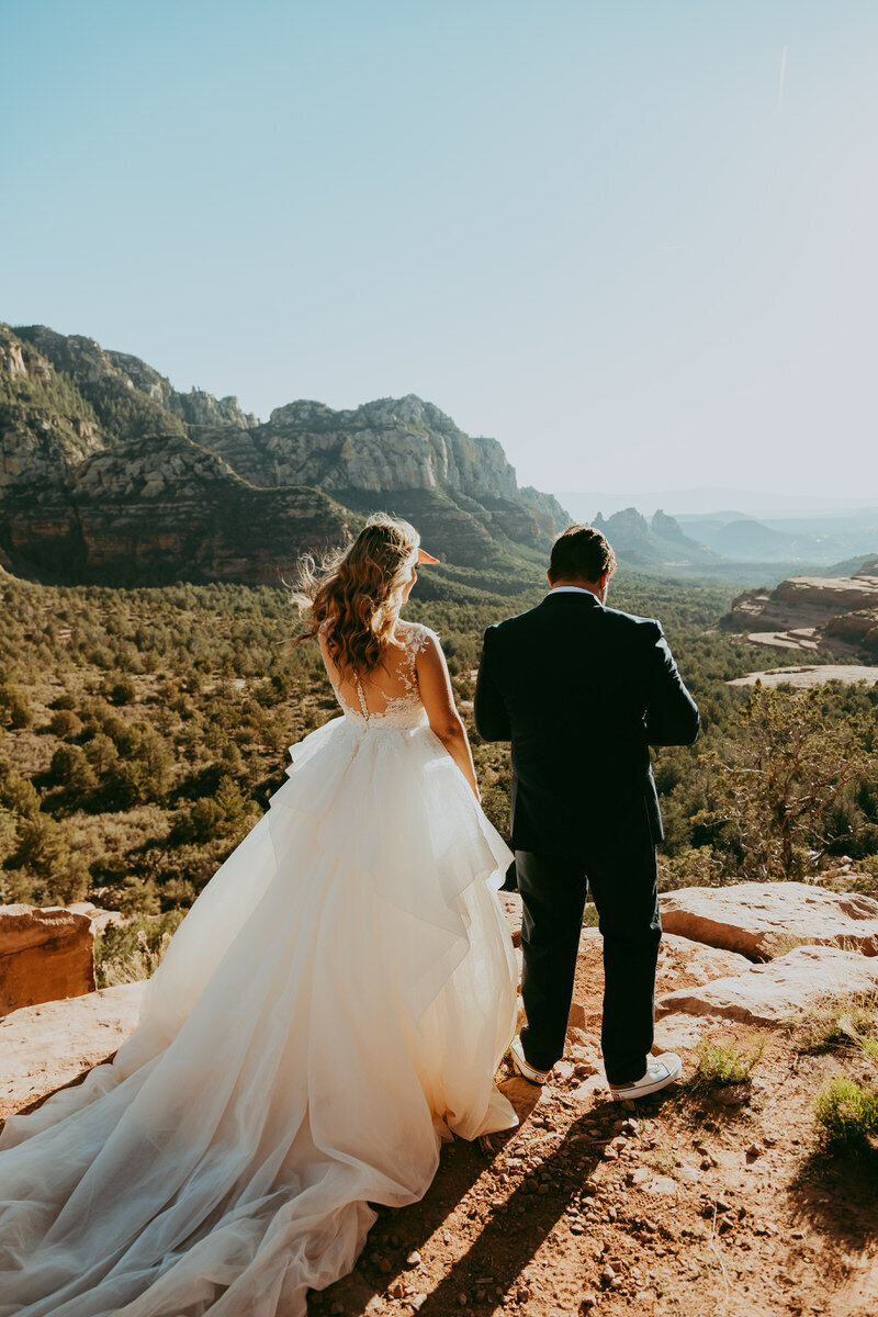 man and woman stand looking at arizona landscape