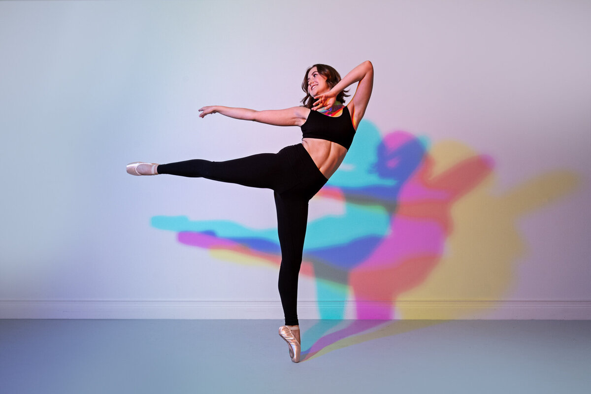 senior photo of dancing Irondale high school girl in studio with colorful lights