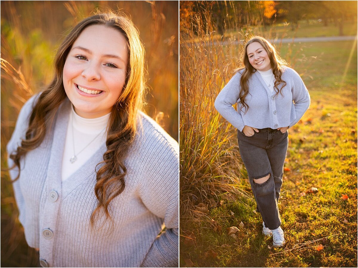 a-smiling-high-school-senior-in-a-light-gray-cardigan-and-black-jeans-standing-in-a-sunlit-field-with-warm-autumn-tones-during-her-indianapolis-senior-portrait-session-southeastway-park
