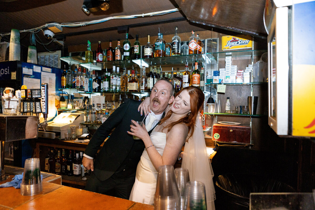 Tattooed couple sharing a candid moment during their alternative engagement studio session in Springfield, MO, photographed by Chelsea Stanford.