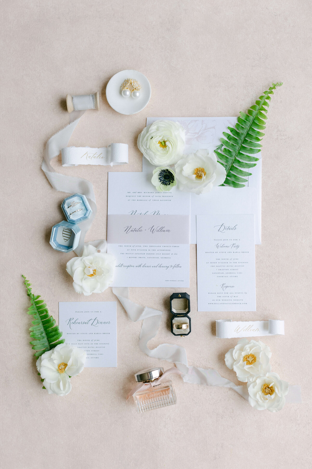 Invitations and rings sit on a white background.
