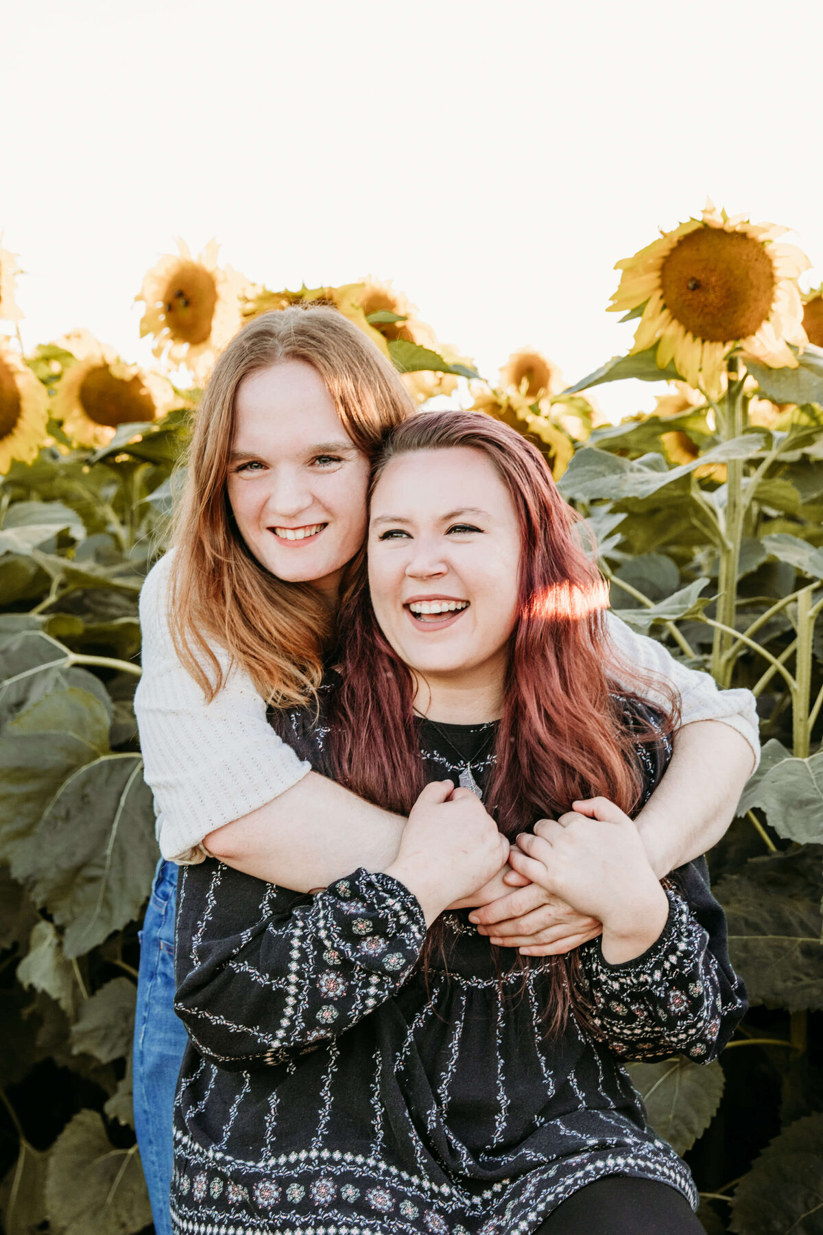 LGBTQ couple with sunflowers  by Ashley Kalbus